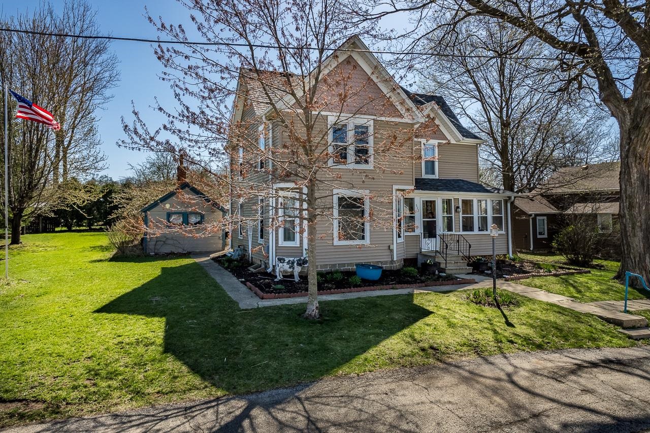 a view of a yard in front of a brick house
