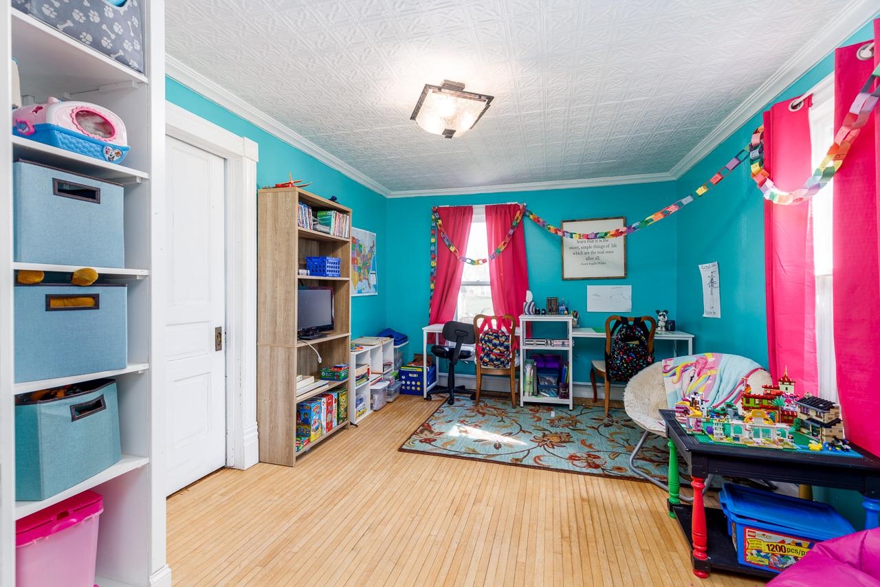 511 North Salisbury Davis, IL 61019 - Photo 17 of 24 a bedroom with a bed a books bucket with a desk and chair
