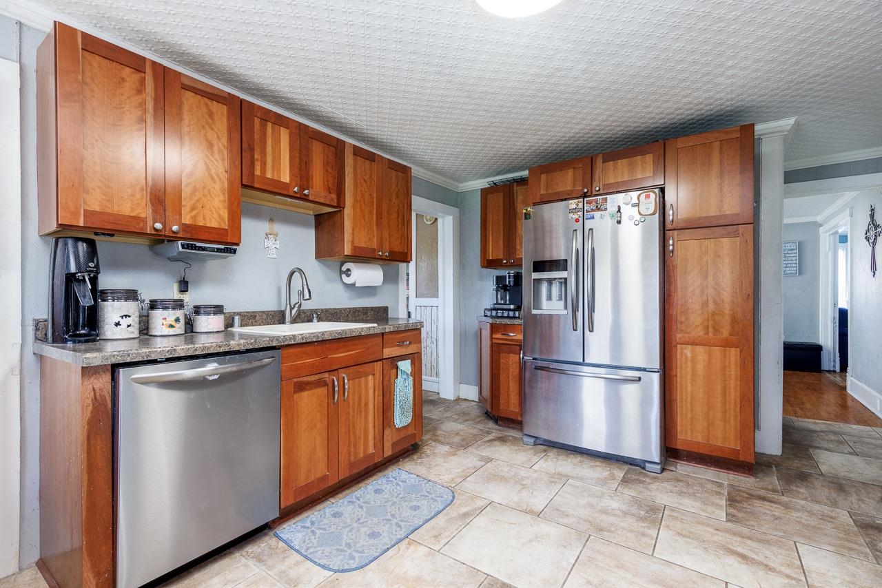 511 North Salisbury Davis, IL 61019 - Photo 6 of 24 a kitchen with stainless steel appliances granite countertop a refrigerator a stove a sink and a microwave