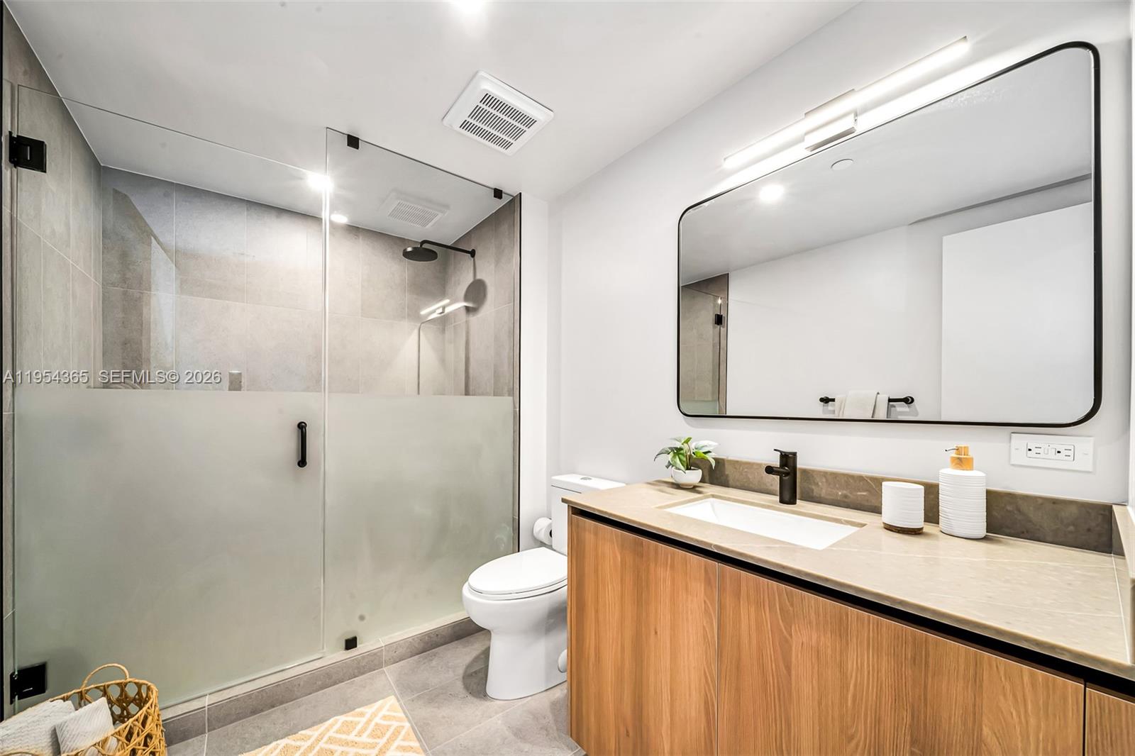121 Northeast 5th Street, Unit 1608 Miami, FL 33132 - Photo 12 of 31 a bathroom with a granite countertop sink mirror vanity and toilet