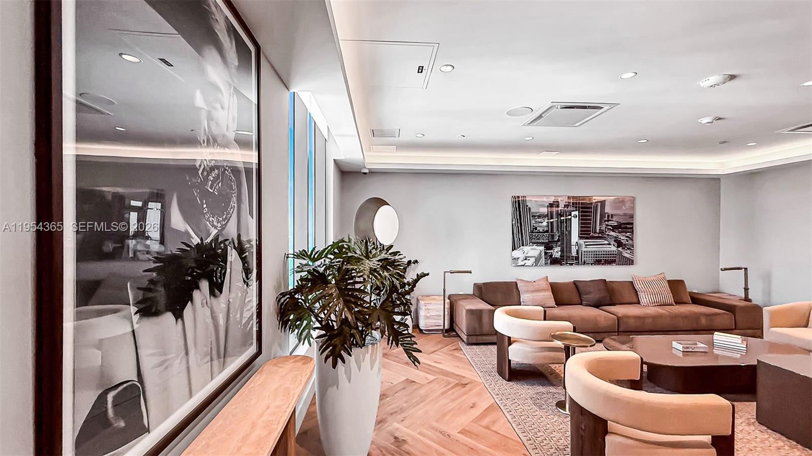 121 Northeast 5th Street, Unit 1608 Miami, FL 33132 - Photo 22 of 31 a living room with furniture and a floor to ceiling window