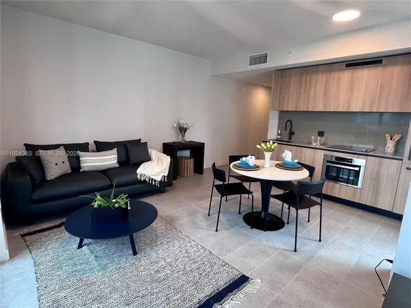 a living room with furniture a rug and a fireplace