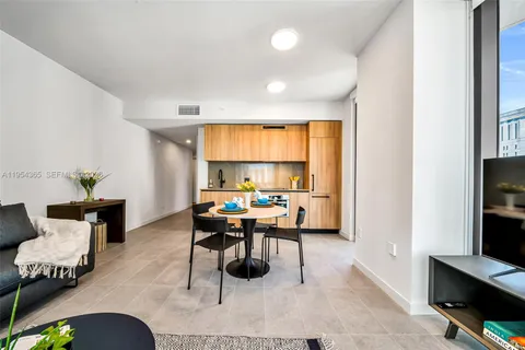 a work room with furniture and a flat screen tv