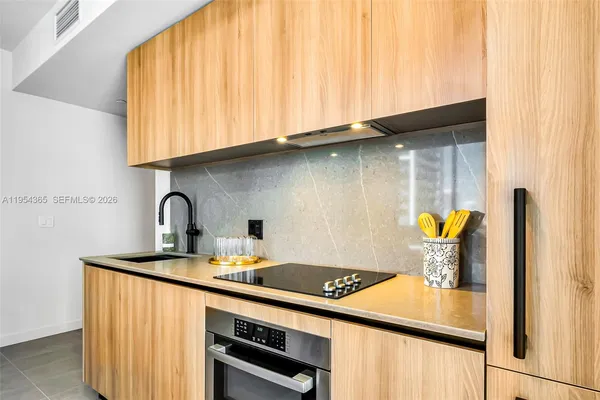 a kitchen with a sink cabinets and appliances