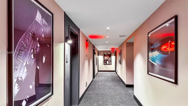 a view of a hallway with windows and furniture