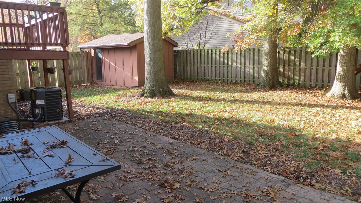 6490 Elmdale Road Cleveland, OH 44130 - Photo 16 of 17 View of yard featuring a storage shed and central AC