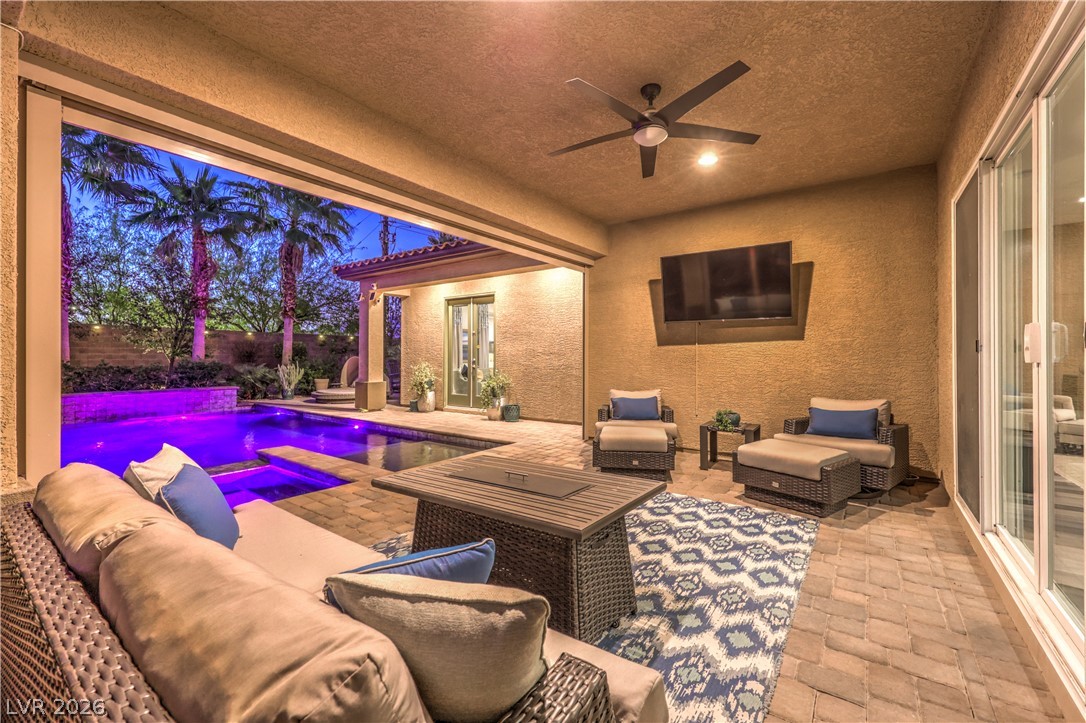 7119 Arabian Ridge Street Las Vegas, NV 89131 - Photo 50 of 73 An inviting outdoor living space features a covered patio with a sparkling pool and spa, perfect for evening relaxation.