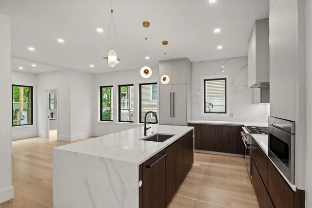 a large kitchen with granite countertop a sink and dishwasher with a large kitchen island