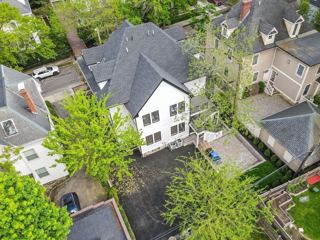 116 Thorndike Street, Unit 1 Brookline, MA 02446 - Photo 9 of 17 an aerial view of a house with a yard and garden