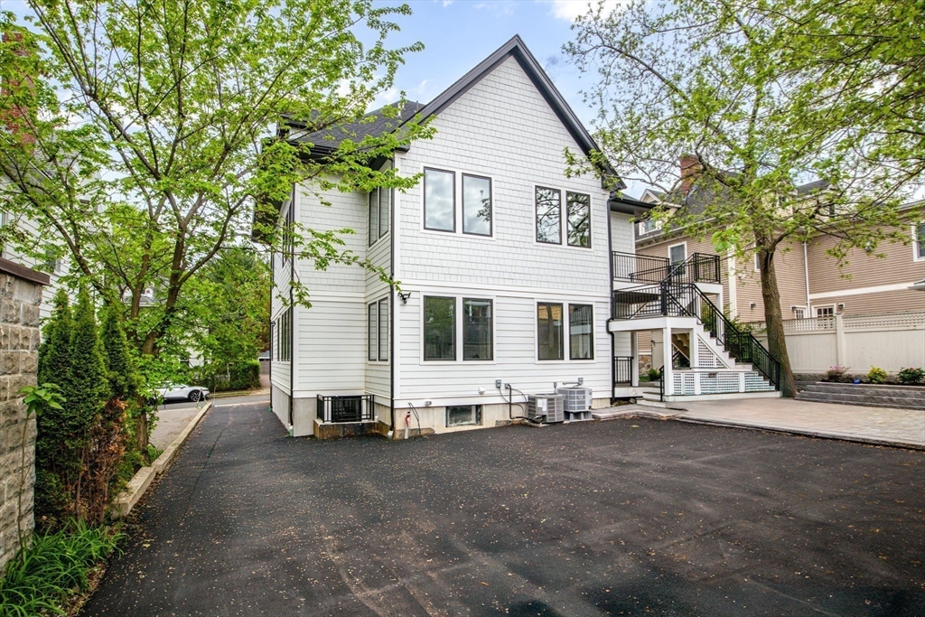 116 Thorndike Street, Unit 1 Brookline, MA 02446 - Photo 10 of 17 a view of a house with a yard