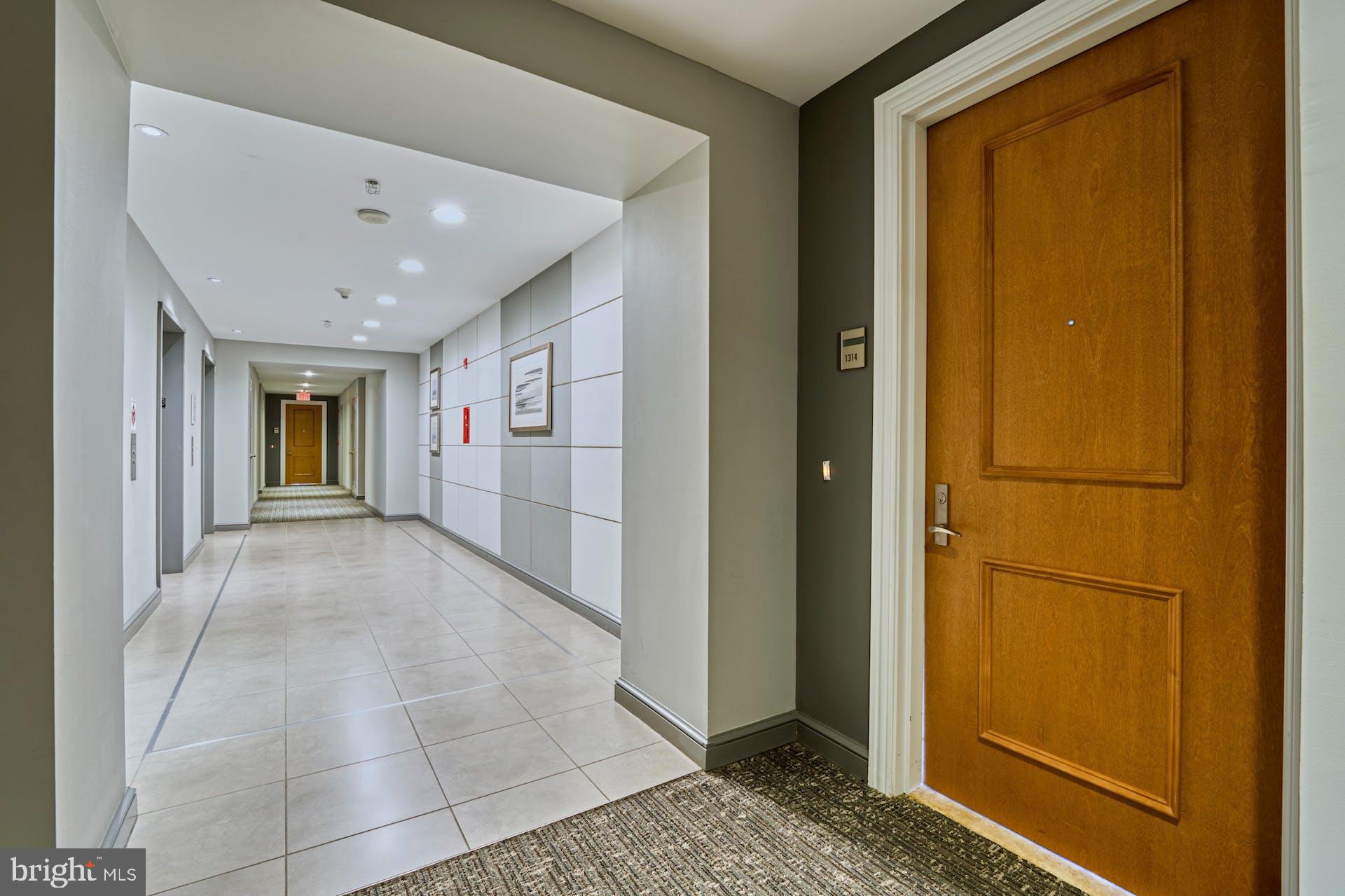 11990 Market Street, Unit 1314 Reston, VA 20190 - Photo 9 of 44 LARGE AND BRIGHT HALLWAY. EASY ACCESS TO ELEVATOR