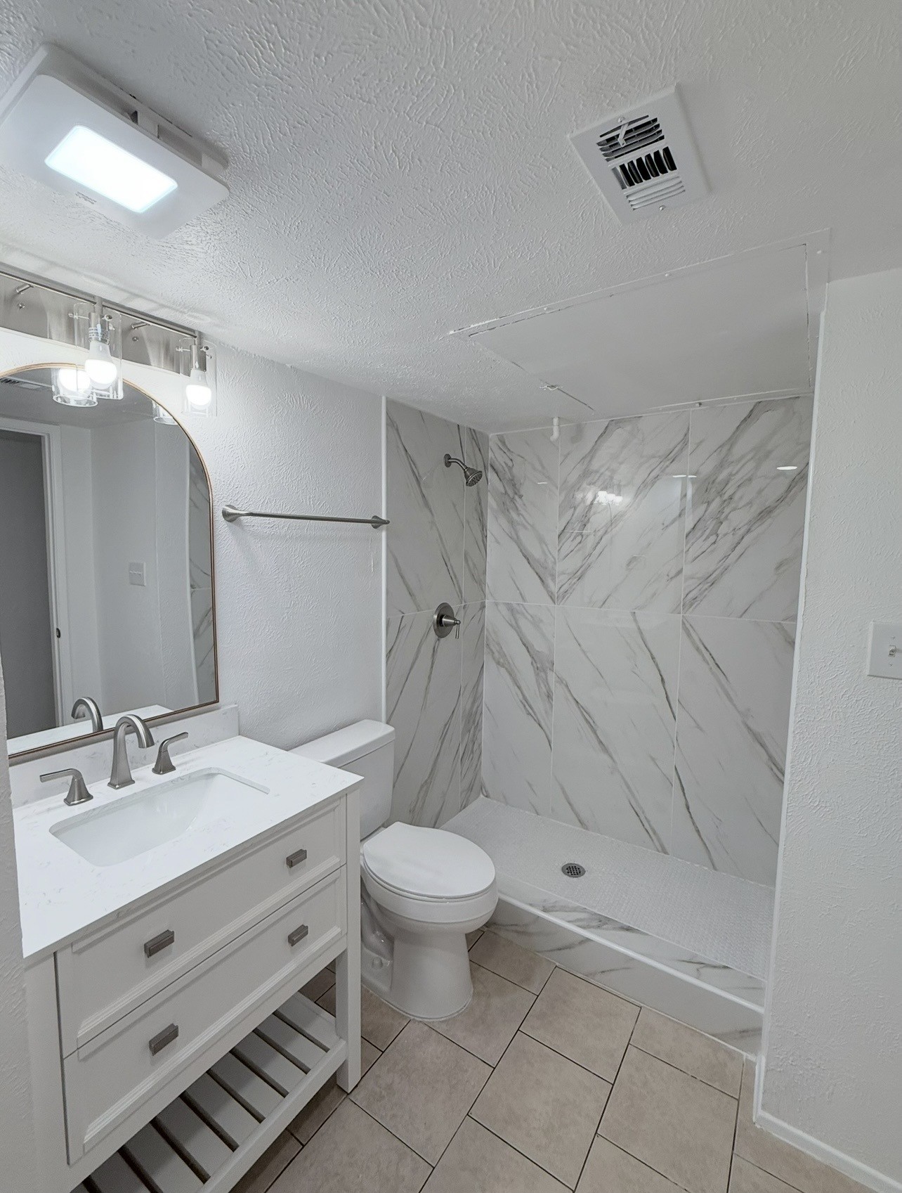 24410 Kennedy Ranch Drive Hockley, TX 77447 - Photo 12 of 20 Updated bathroom with large tile on the walls and penny tile on the floor.