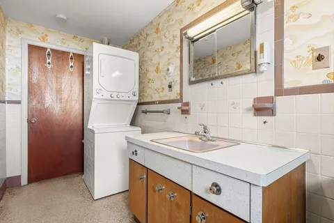a utility room with a sink a washer and dryer