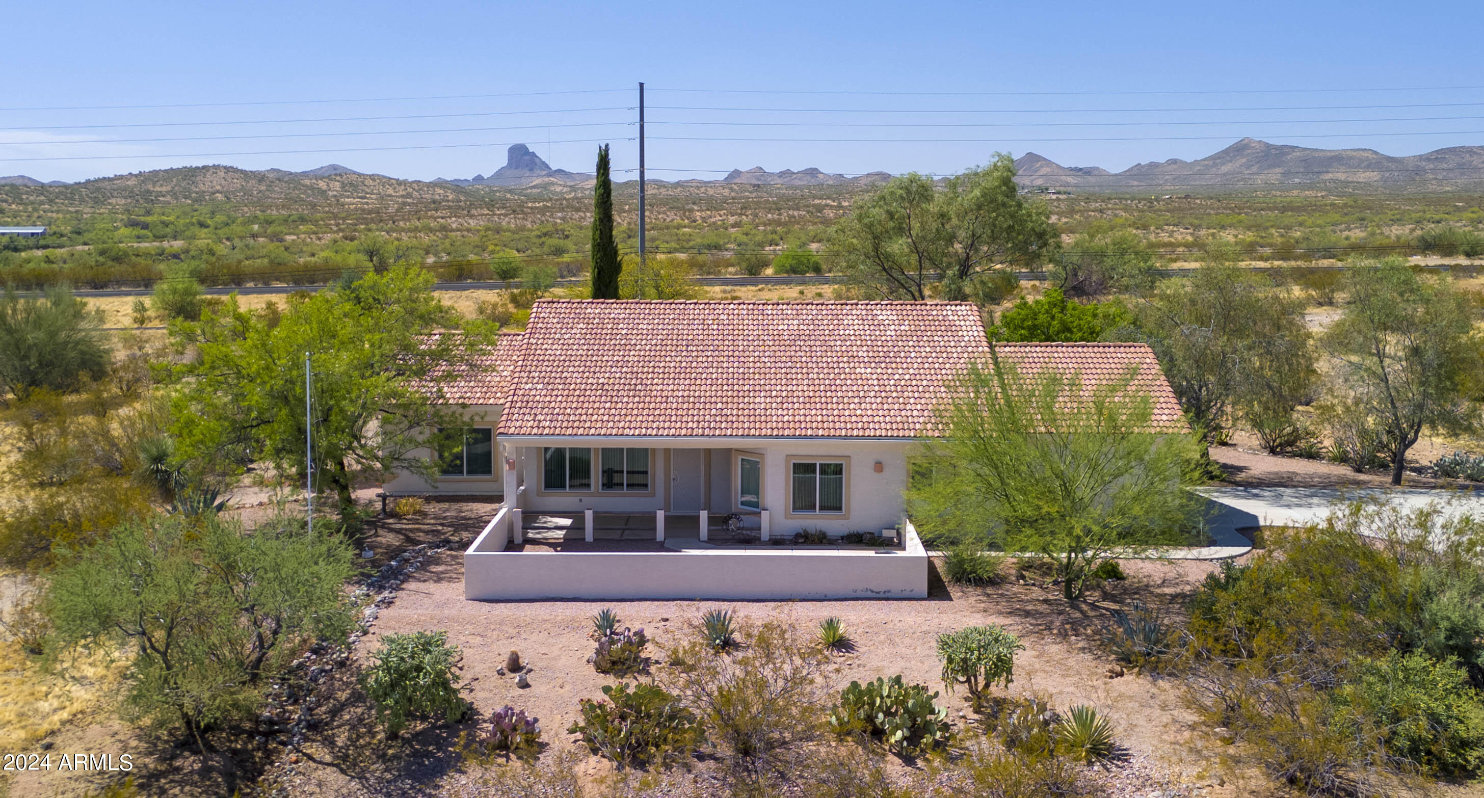 2825 West Pinto Place Wickenburg, AZ 85390 - Photo 1 of 32 a front view of a house with a yard