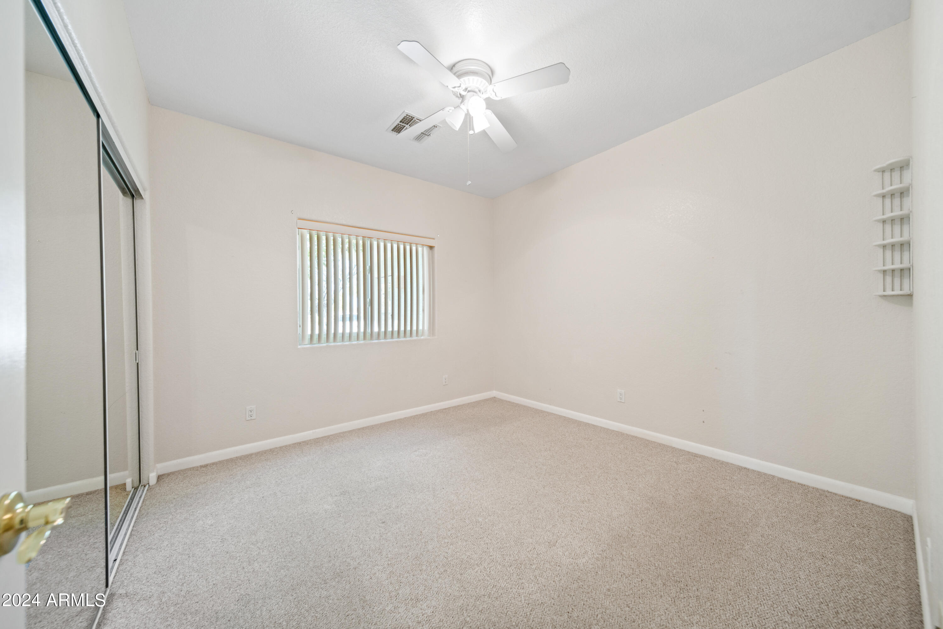 2825 West Pinto Place Wickenburg, AZ 85390 - Photo 17 of 32 an empty room with windows and fan