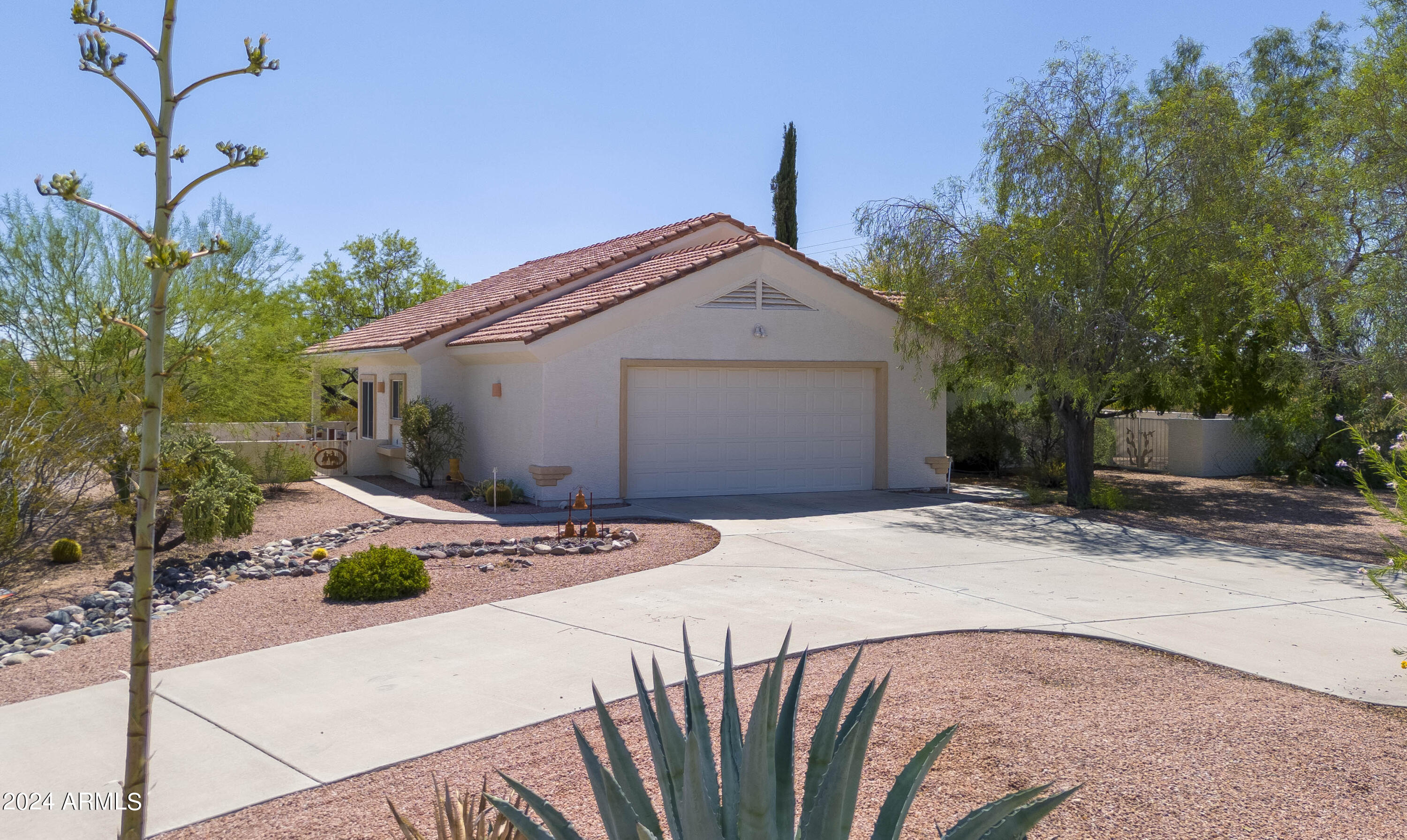 2825 West Pinto Place Wickenburg, AZ 85390 - Photo 4 of 32 a patio with table and chairs and potted plants