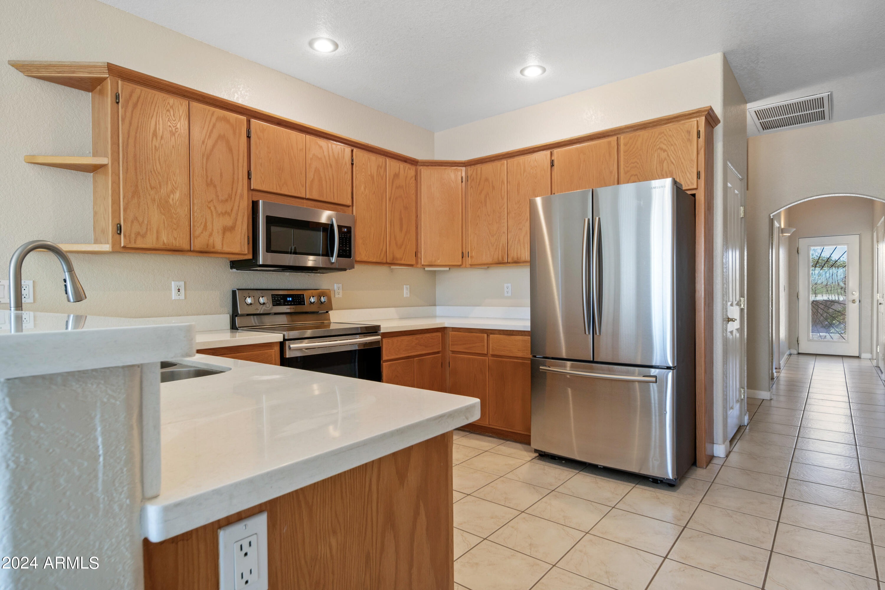 2825 West Pinto Place Wickenburg, AZ 85390 - Photo 10 of 32 a kitchen with stainless steel appliances granite countertop a refrigerator sink and microwave