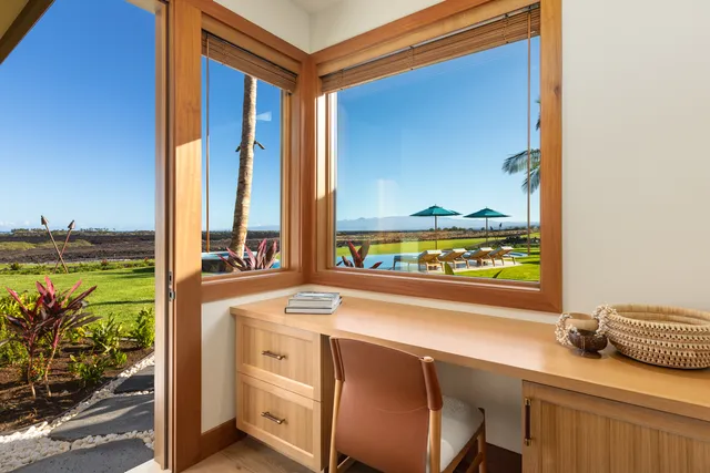 a room with a bed and a view of kitchen