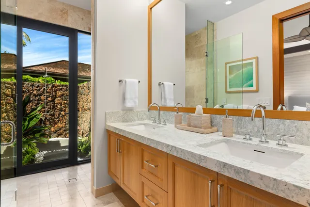 a bathroom with a double vanity sink and a mirror