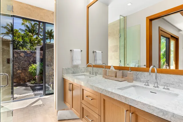 a bathroom with a double vanity sink and a mirror