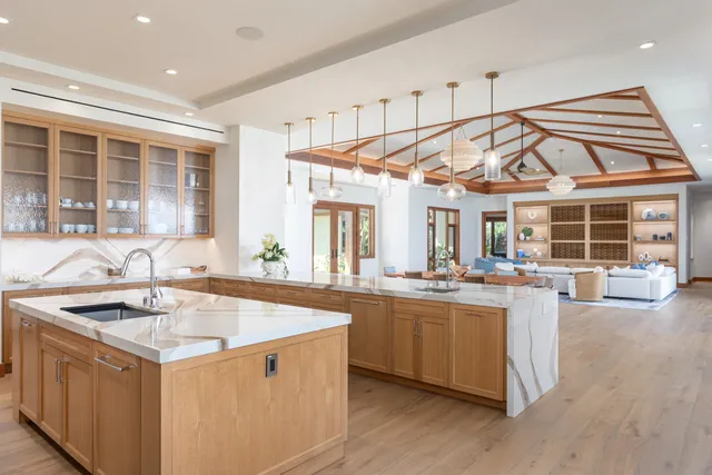 a kitchen with stainless steel appliances granite countertop a sink and a stove