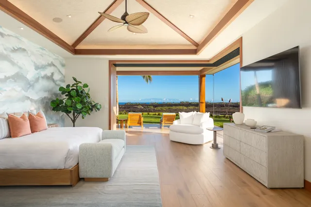 a bedroom with furniture and a large window