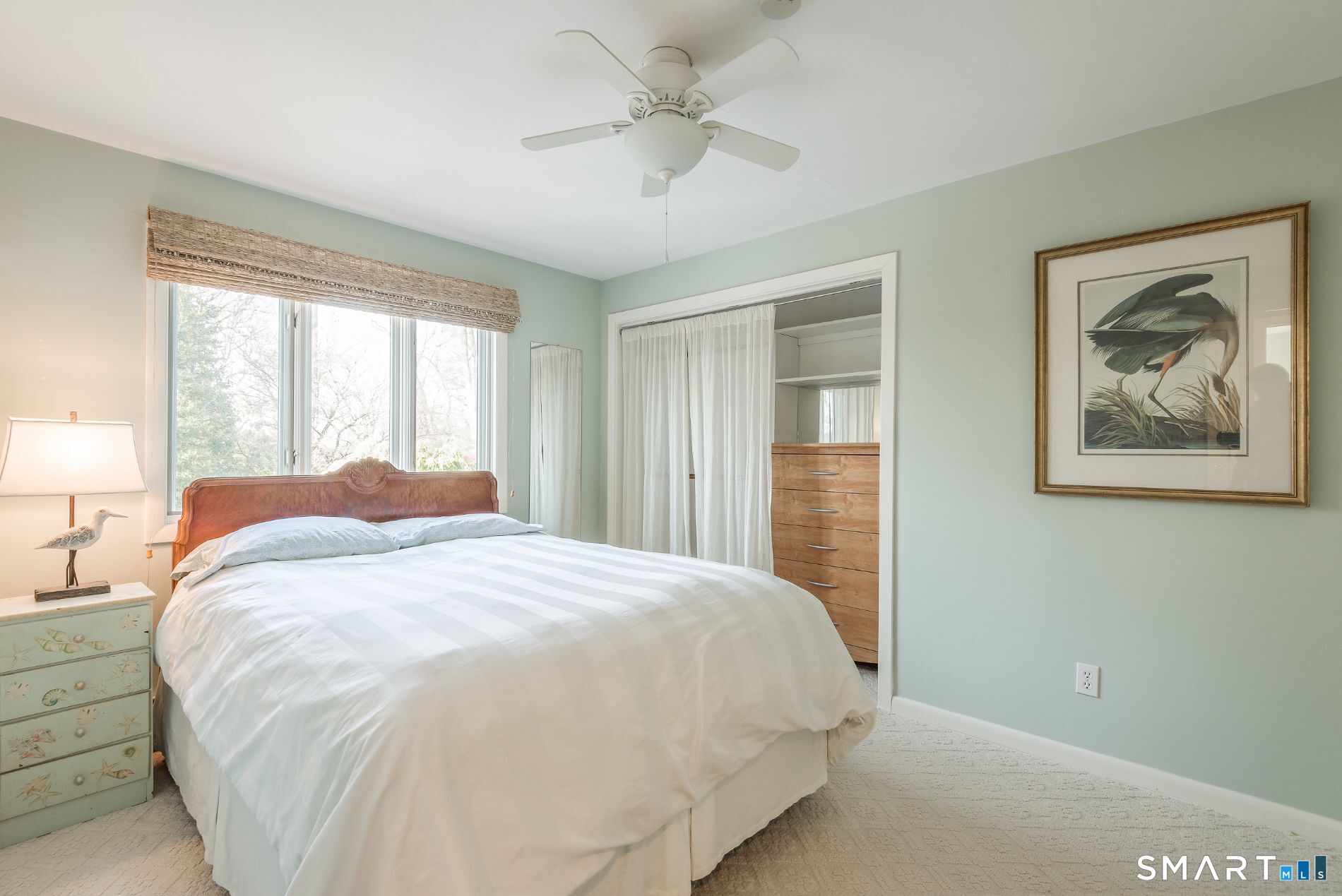 31 Splitrock Road Norwalk, CT 06854 - Photo 32 of 38 a bedroom with a large bed and a chandelier