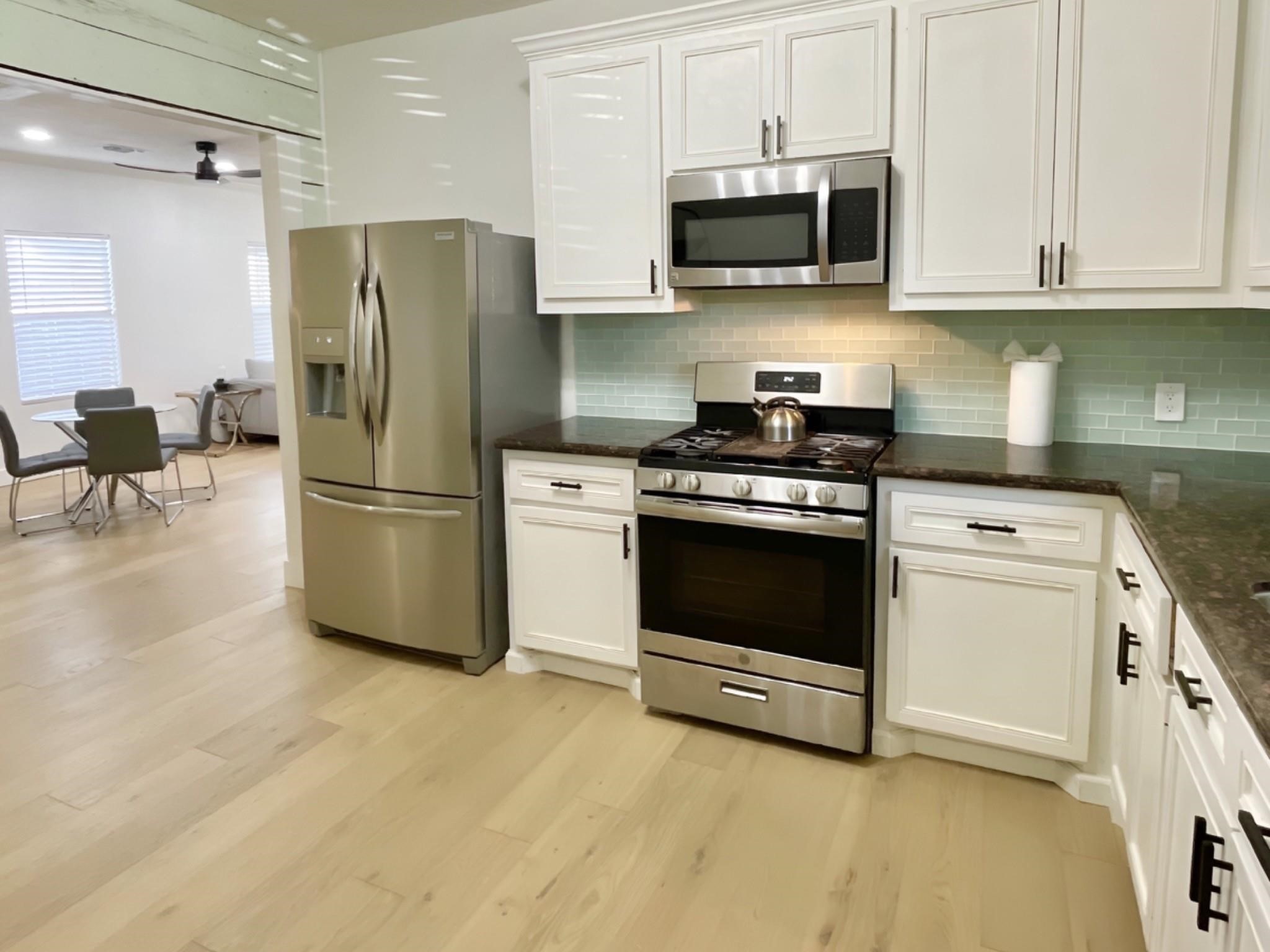 301 Tabor Street Houston, TX 77009 - Photo 28 of 33 a kitchen with a stove and a refrigerator