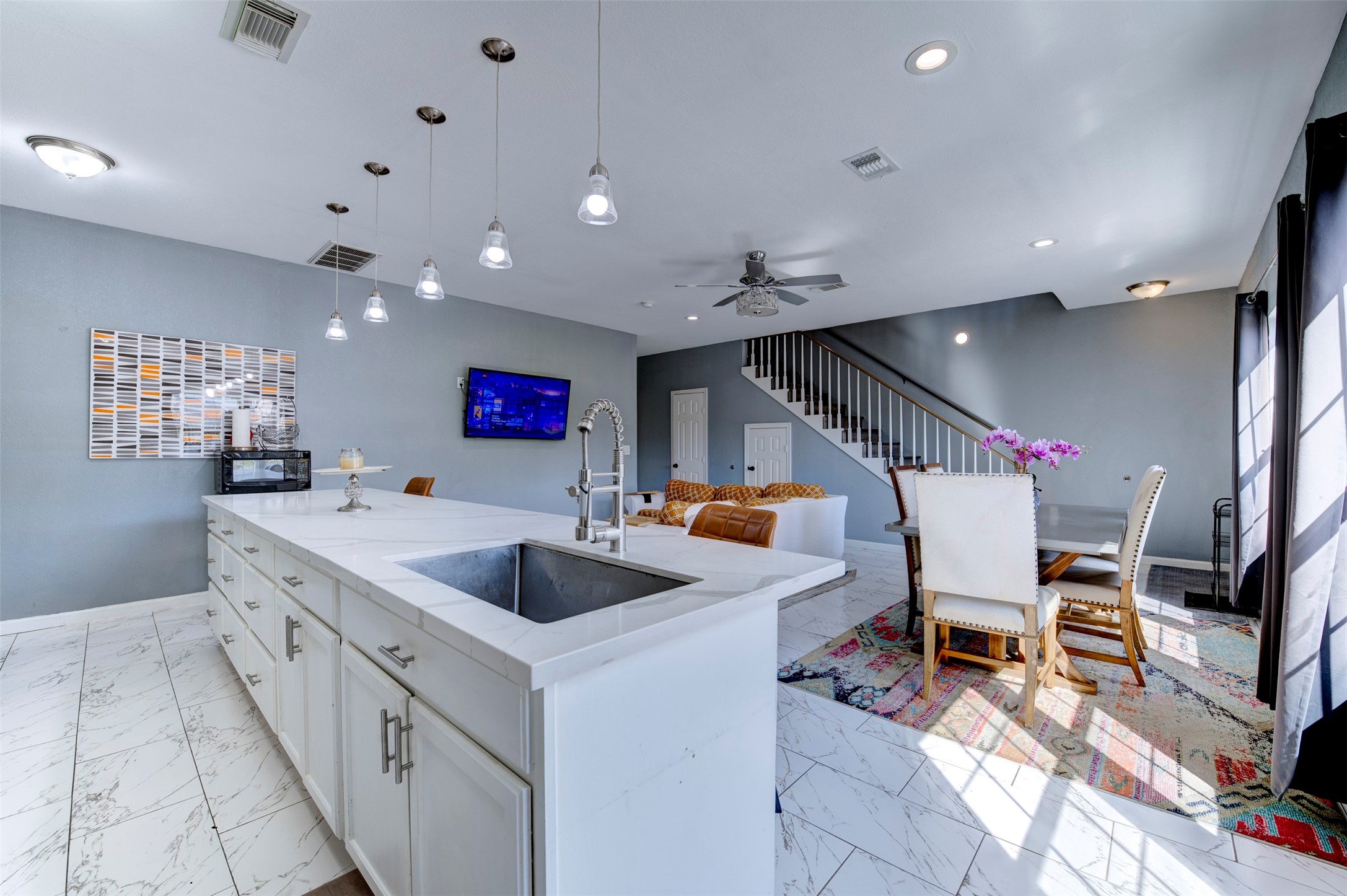 301 Tabor Street Houston, TX 77009 - Photo 8 of 33 a kitchen with stainless steel appliances kitchen island granite countertop a sink and a refrigerator