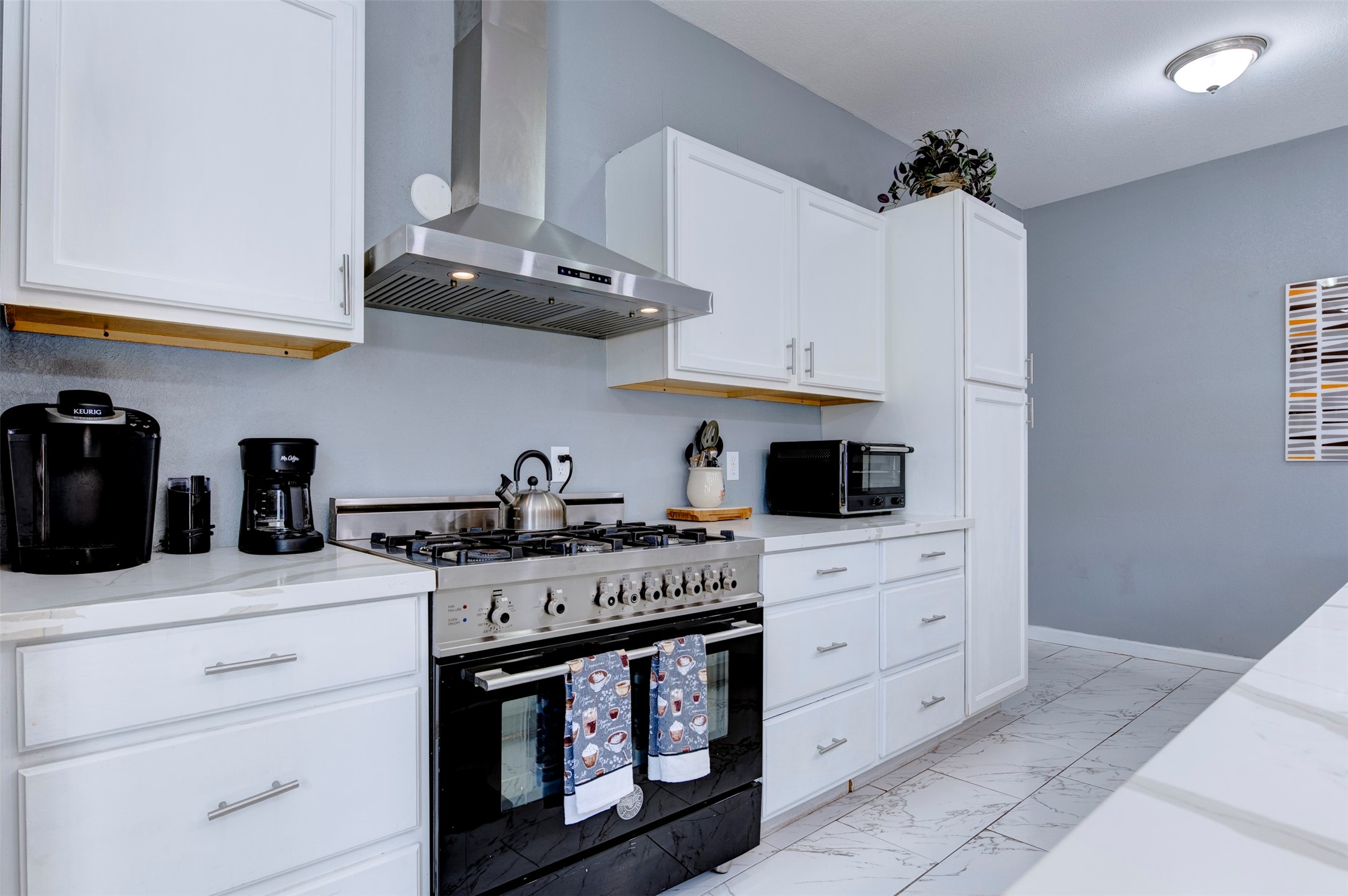 301 Tabor Street Houston, TX 77009 - Photo 9 of 33 a kitchen with stainless steel appliances white cabinets and a stove top oven