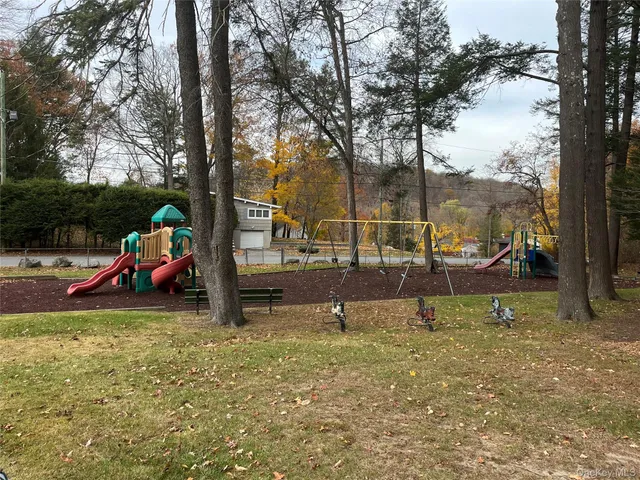 a view of a park with swings and slides