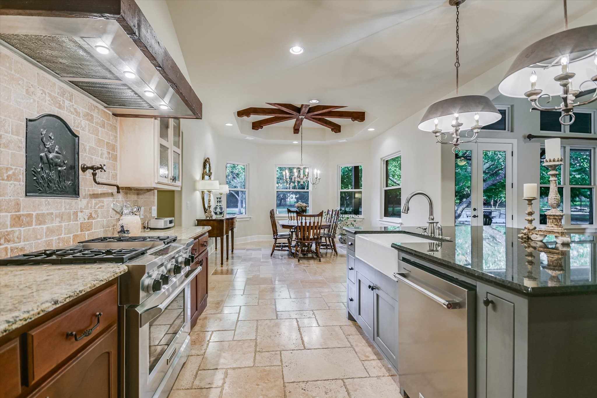 112 Gabriel Vista East Georgetown, TX 78633 - Photo 12 of 34 a kitchen with stainless steel appliances granite countertop a stove oven a sink dishwasher and a dining table with granite countertops