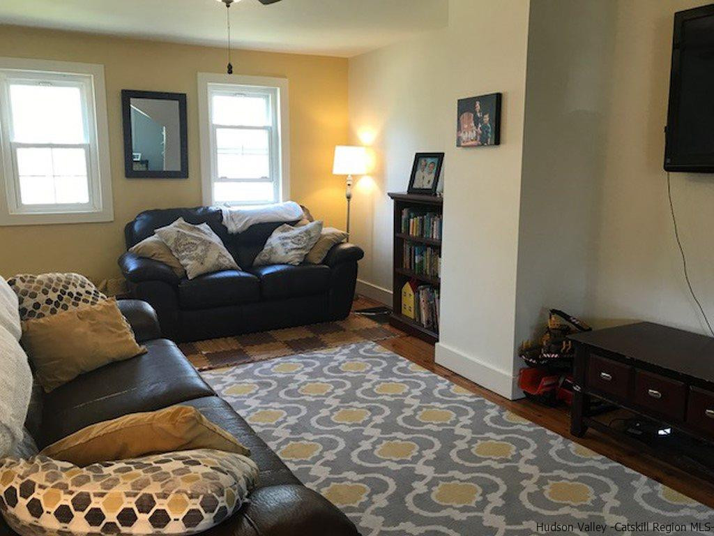 183 Beecher Hill Road Wallkill, NY 12589 - Photo 11 of 33 a living room with furniture and a window