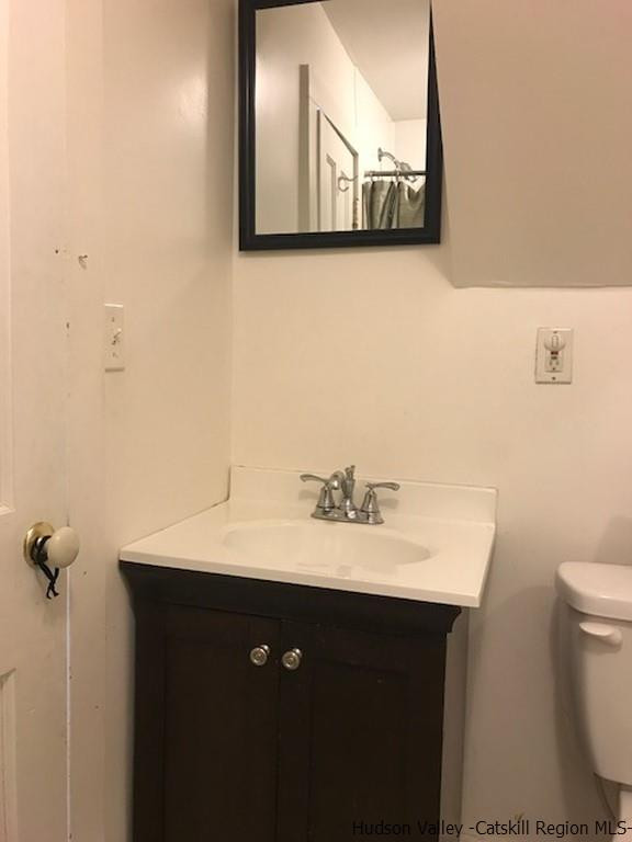 183 Beecher Hill Road Wallkill, NY 12589 - Photo 12 of 33 a bathroom with a toilet sink and mirror