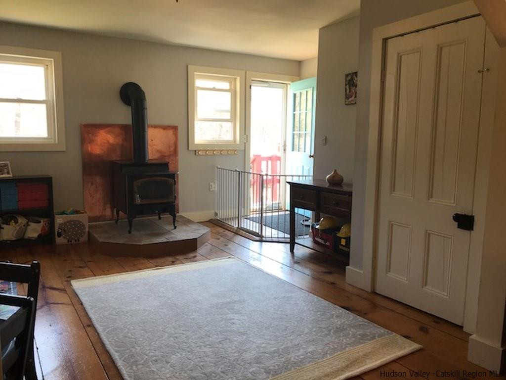 183 Beecher Hill Road Wallkill, NY 12589 - Photo 5 of 33 a living room with furniture and a fireplace