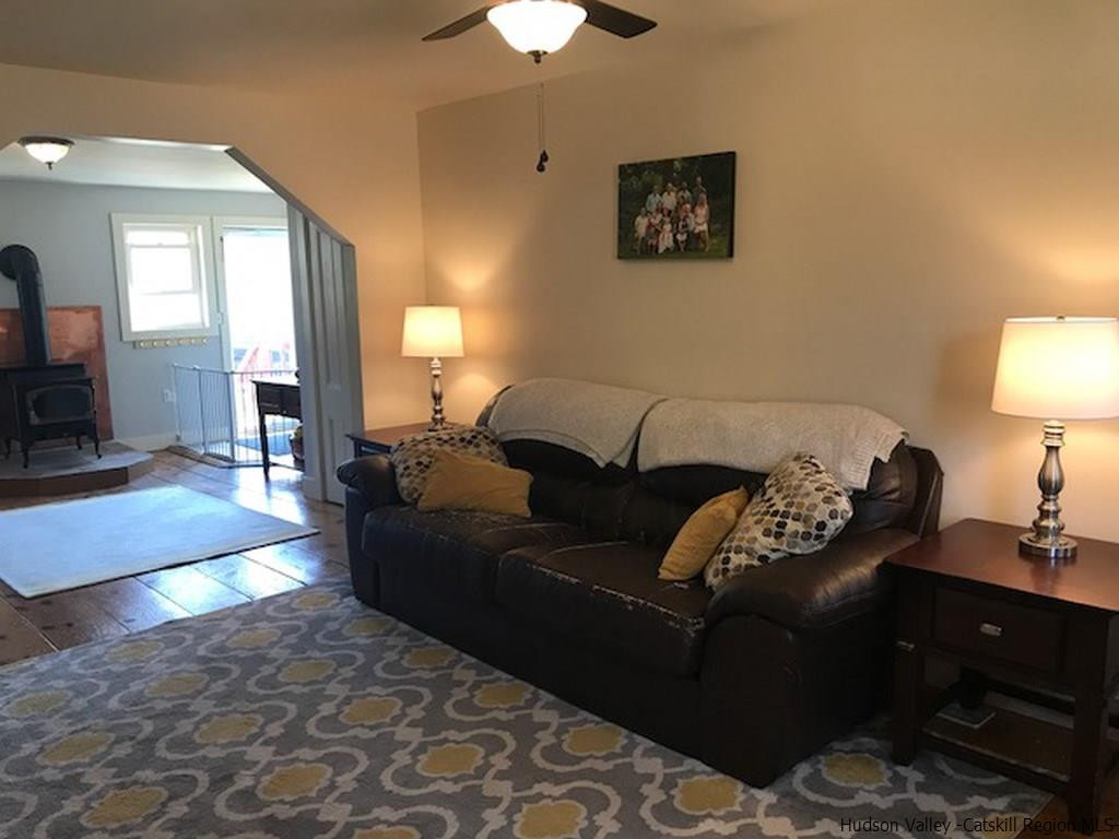 183 Beecher Hill Road Wallkill, NY 12589 - Photo 6 of 33 a living room with furniture and a lamp