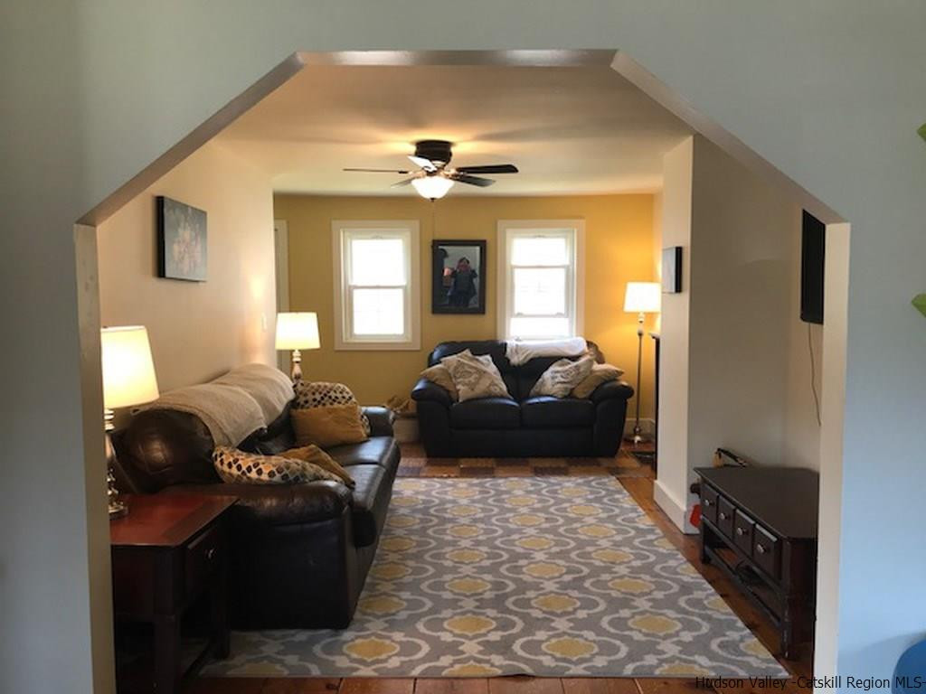 183 Beecher Hill Road Wallkill, NY 12589 - Photo 8 of 33 a living room with furniture and a chandelier