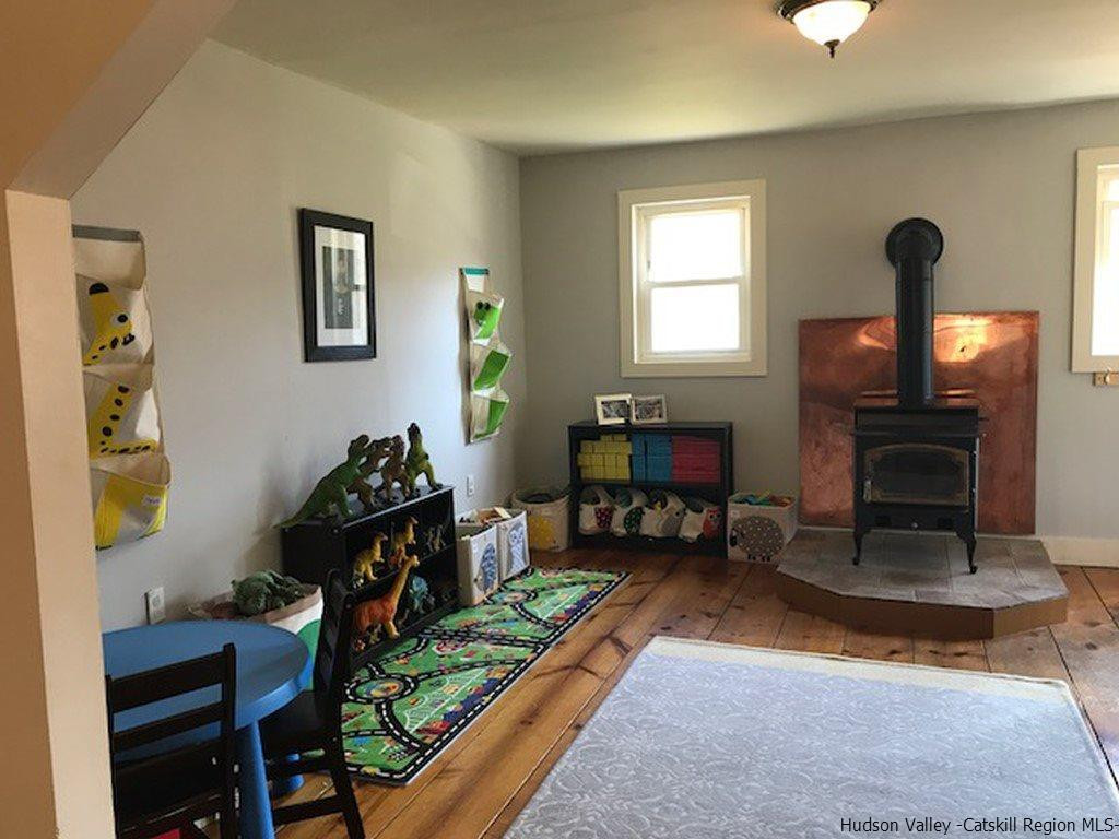 183 Beecher Hill Road Wallkill, NY 12589 - Photo 9 of 33 a living room with furniture and a fireplace