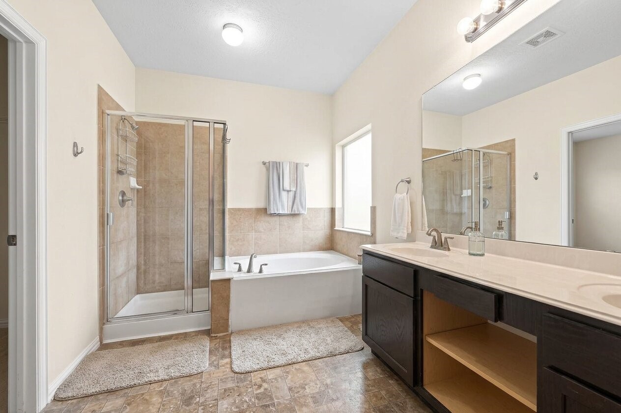 8106 Rudy Brook Way Spring, TX 77379 - Photo 13 of 20 a bathroom with a tub a sink and a shower