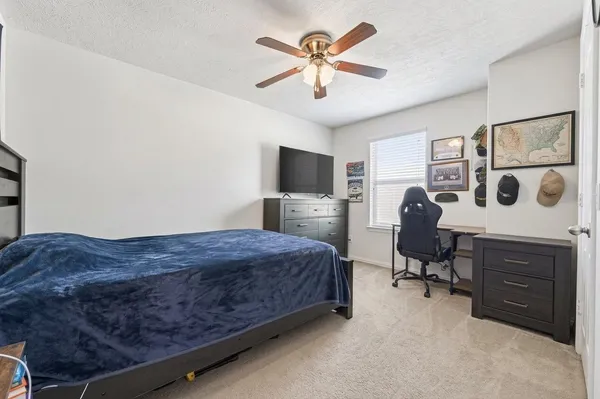 a bedroom with a bed dresser and a window