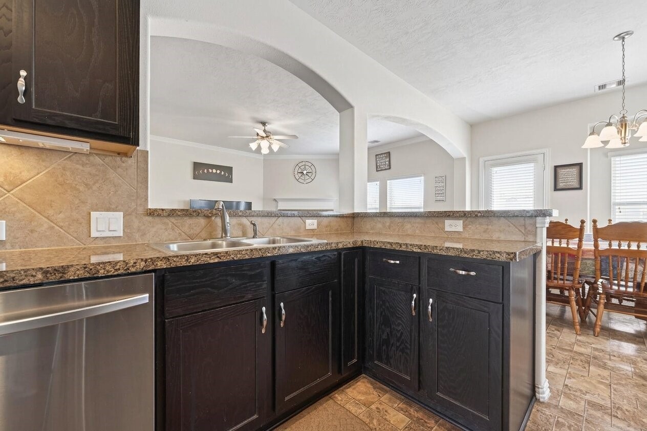 8106 Rudy Brook Way Spring, TX 77379 - Photo 9 of 20 a kitchen with granite countertop a sink and cabinets