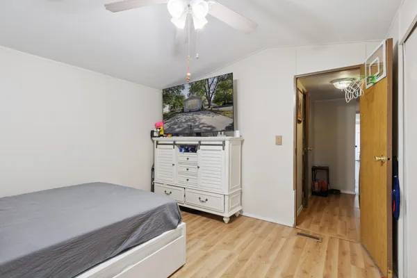 a view of a bedroom with wooden floor