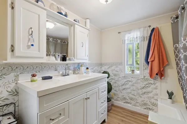 a bathroom with a sink vanity and mirror
