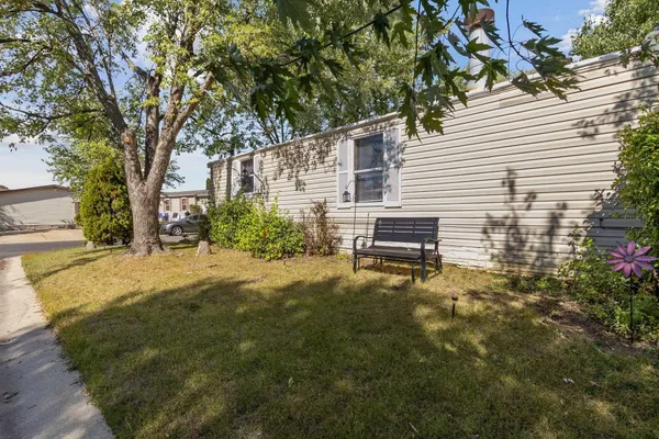 a backyard of a house with table and chairs
