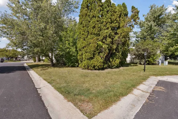 a view of a pathway with a wrought fence