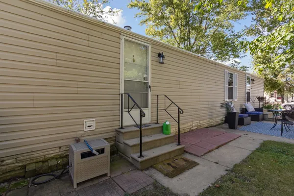 a view of a patio with table and chairs and wooden fence