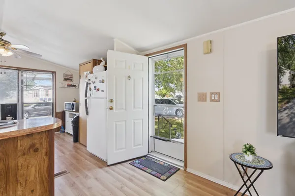 a view of a livingroom with furniture and a hallway