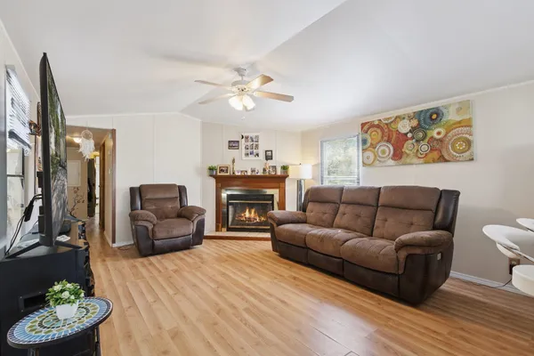 a living room with furniture a fireplace and a flat screen tv