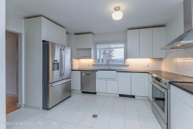 a kitchen with stainless steel appliances granite countertop a refrigerator sink and cabinets