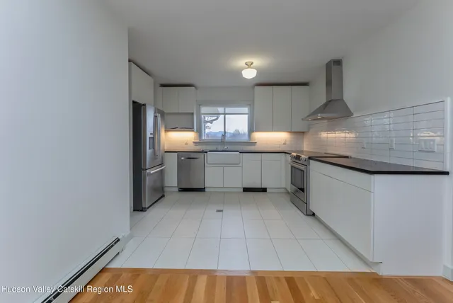 a kitchen with stainless steel appliances granite countertop a sink and cabinets